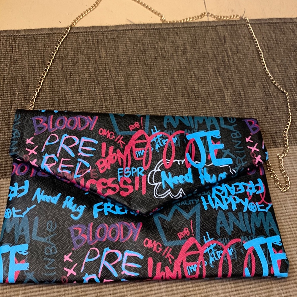 Akira graffiti clutch with gold chain. $25.